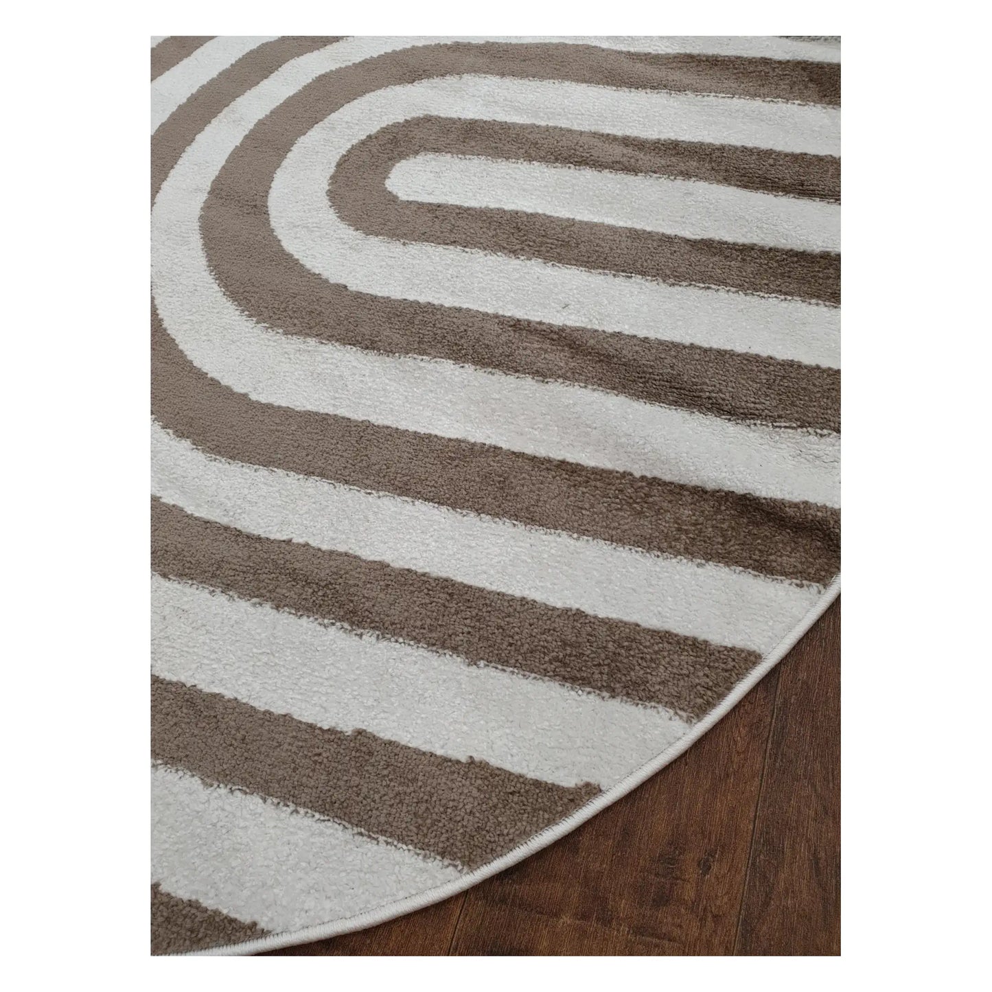 Angled detail of taupe round rug showing curved stripe pattern and edge finish, 160 cm