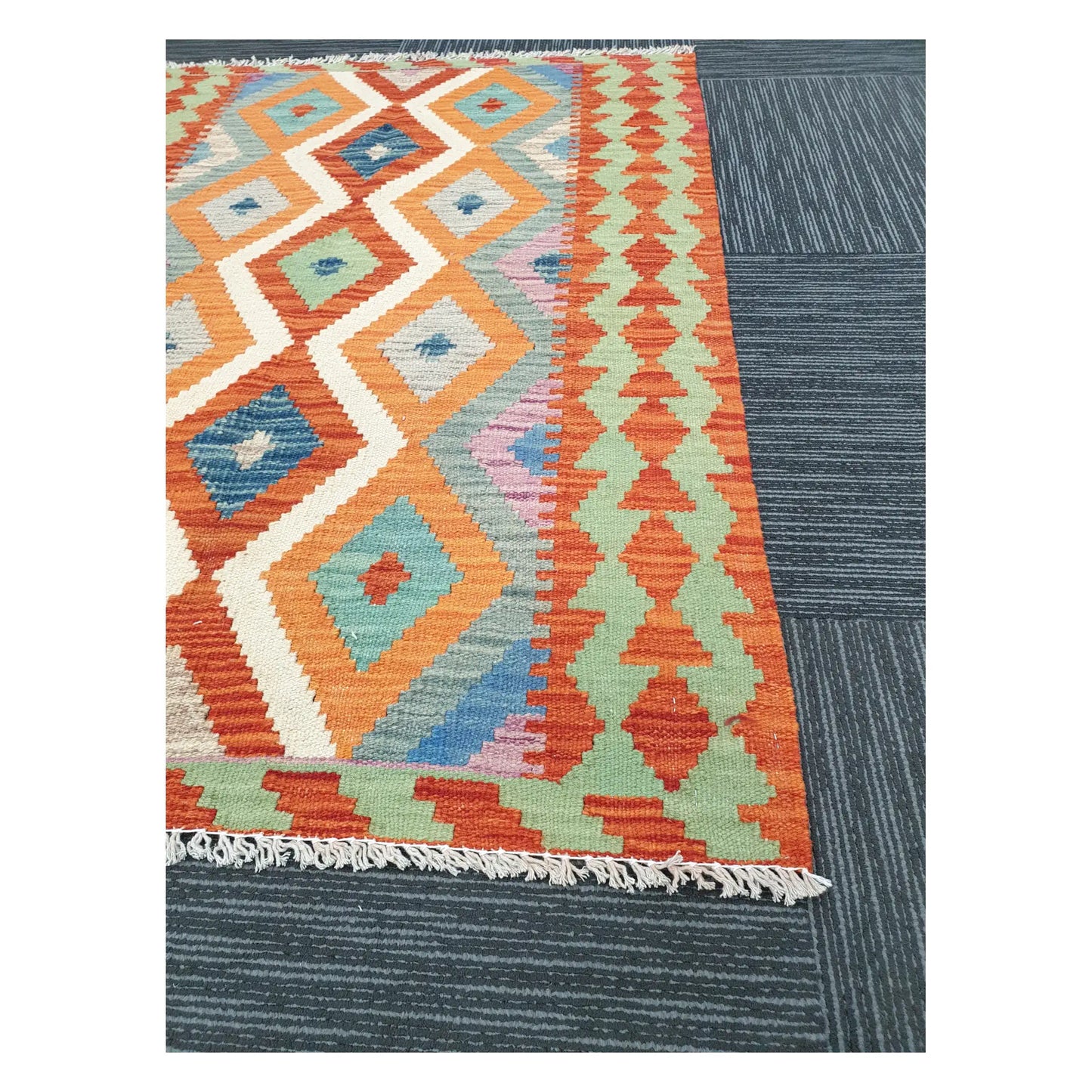 Angled detail of Afghan Chobi Kilim showing fringe, terracotta border motifs, and flatweave texture, 126 x 90 cm