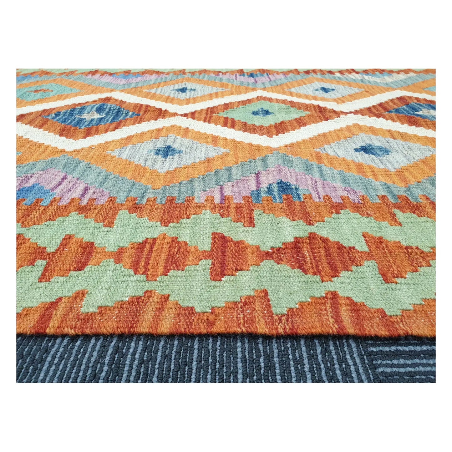 Low-angle close-up of Afghan Chobi Kilim showing wool flatweave texture and geometric border detail, 126 x 90 cm