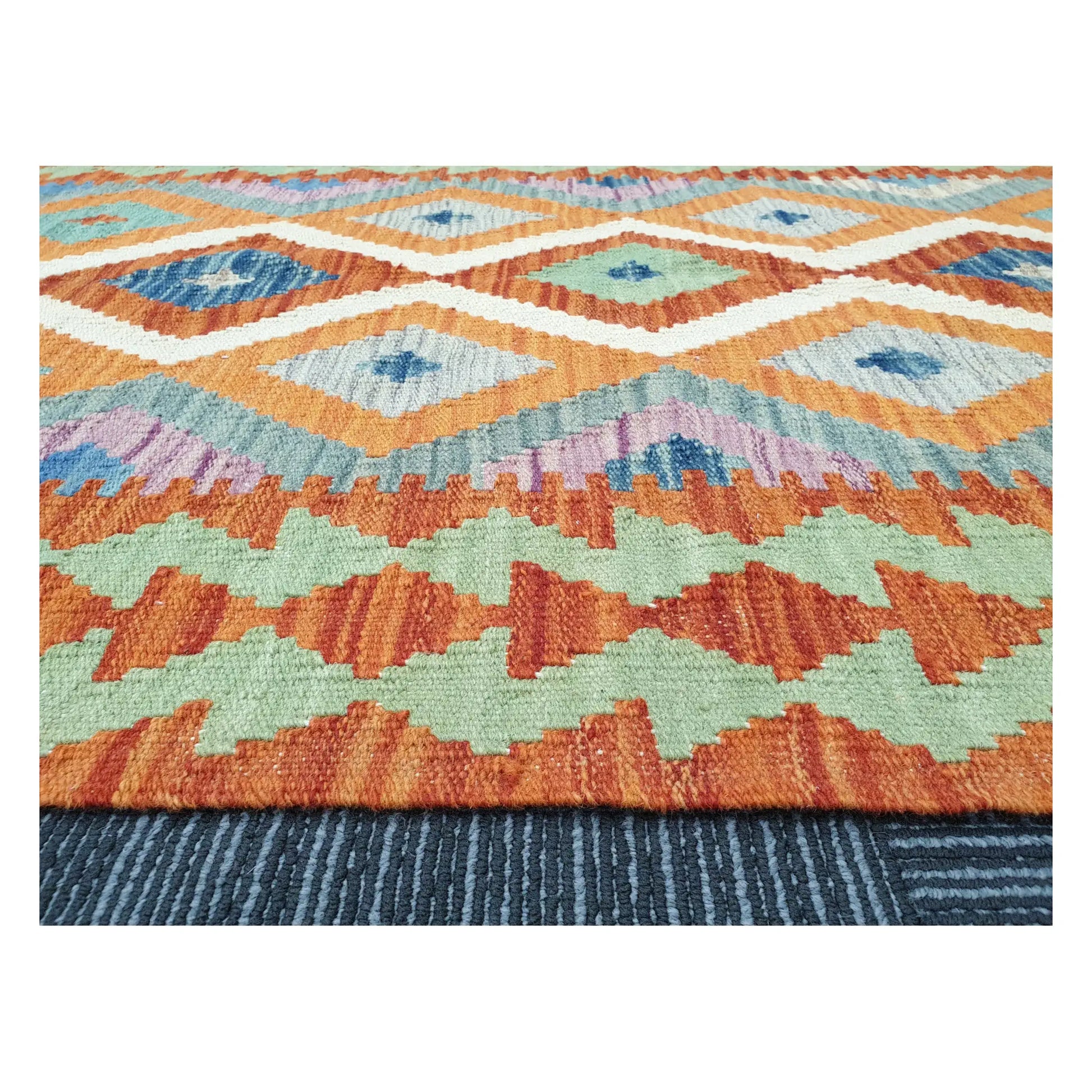 Low-angle close-up of Afghan Chobi Kilim showing wool flatweave texture and geometric border detail, 126 x 90 cm