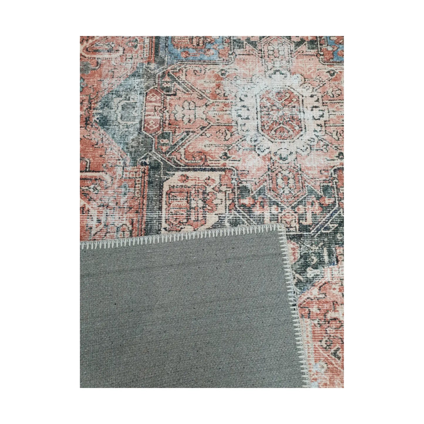 Close-up of terracotta blue cotton rug corner with back and edge detail