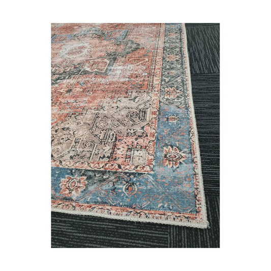 Close-up of terracotta blue cotton rug corner with ornamental border detail