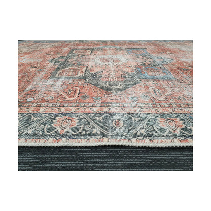 Low-angle close-up of terracotta blue cotton rug edge and border pattern