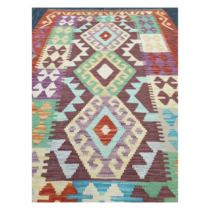 Close-up of Chobi Kilim rug with stacked diamond medallions in ivory, mint, lavender, and rust, 143 x 107 cm