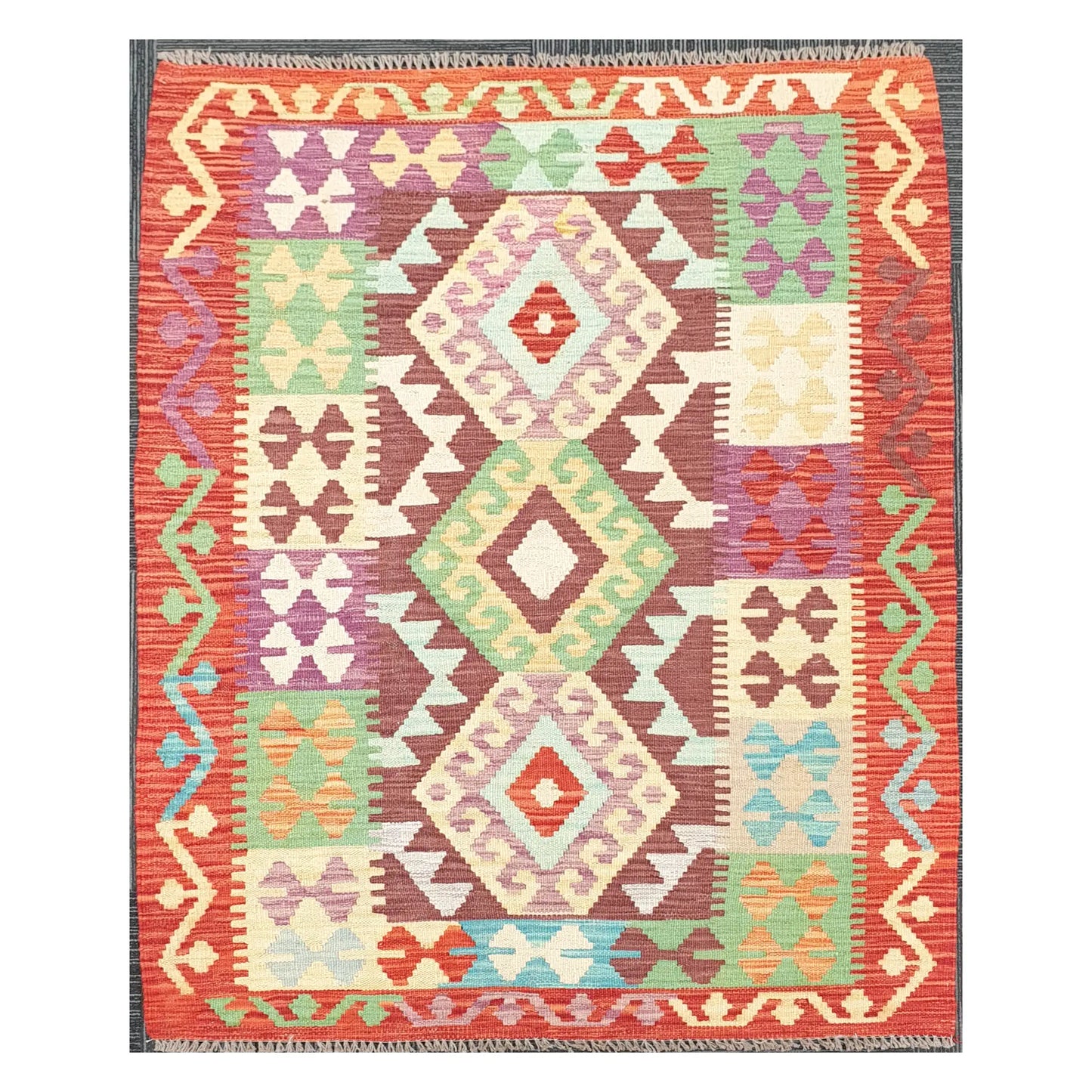 Full view of Afghan Chobi Kilim rug with terracotta border and stacked diamond medallions, 143 x 107 cm