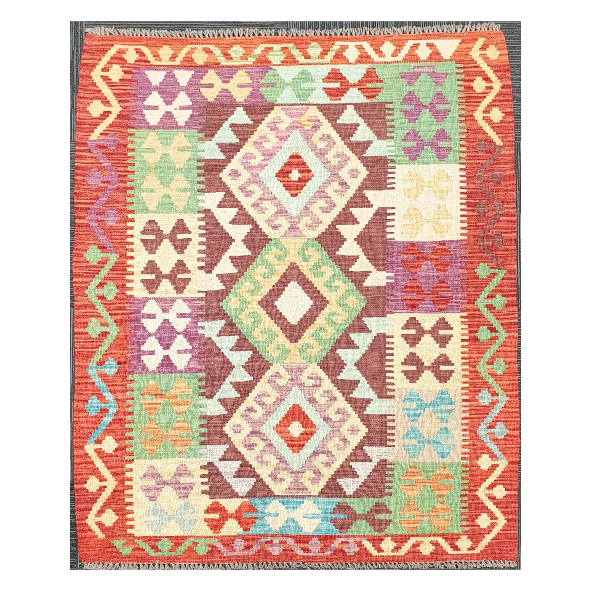 Full view of Afghan Chobi Kilim rug with terracotta border and stacked diamond medallions, 143 x 107 cm