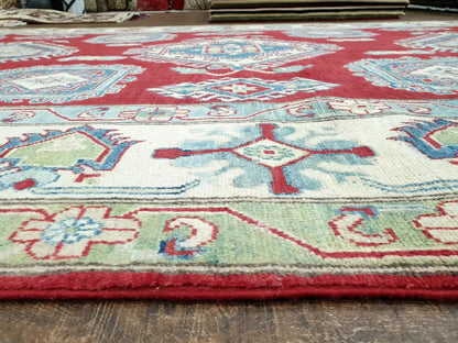 Detailed view of the traditional geometric border design on a red Kazak wool rug, showcasing authentic hand-knotted craftsmanship.
