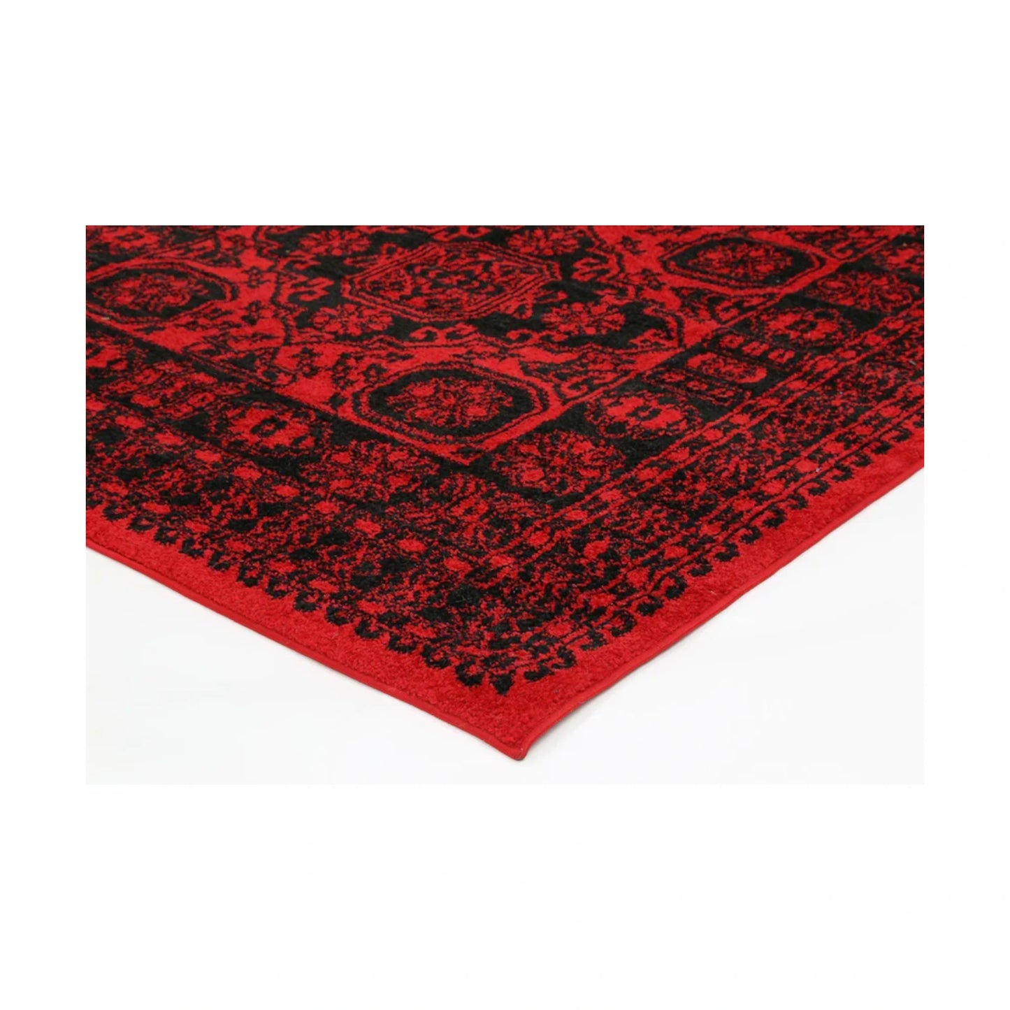 Corner detail of Tribe 10 Red Black rug showing bound edge, red black pattern and polypropylene pile texture, 290 x 200 cm