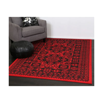 Styled angle view of Tribe 10 Red Black rug showing red field, black motifs and low-profile pile, 290 x 200 cm