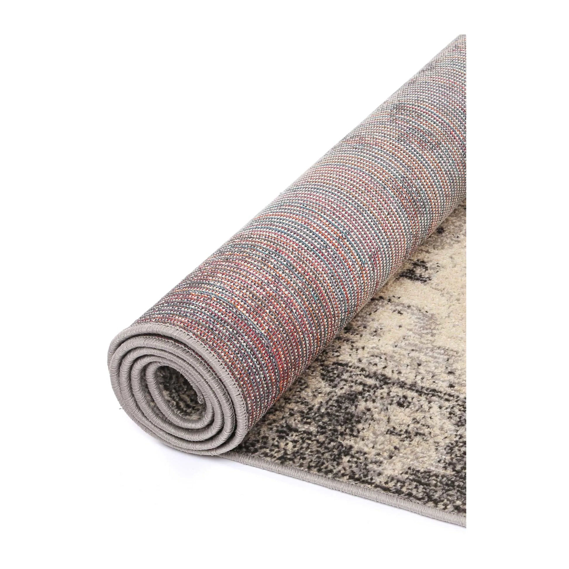 Rolled edge detail of Tulin 12 Warm Cream and Grey rug showing backing, binding and polypropylene pile texture, 230 x 160 cm