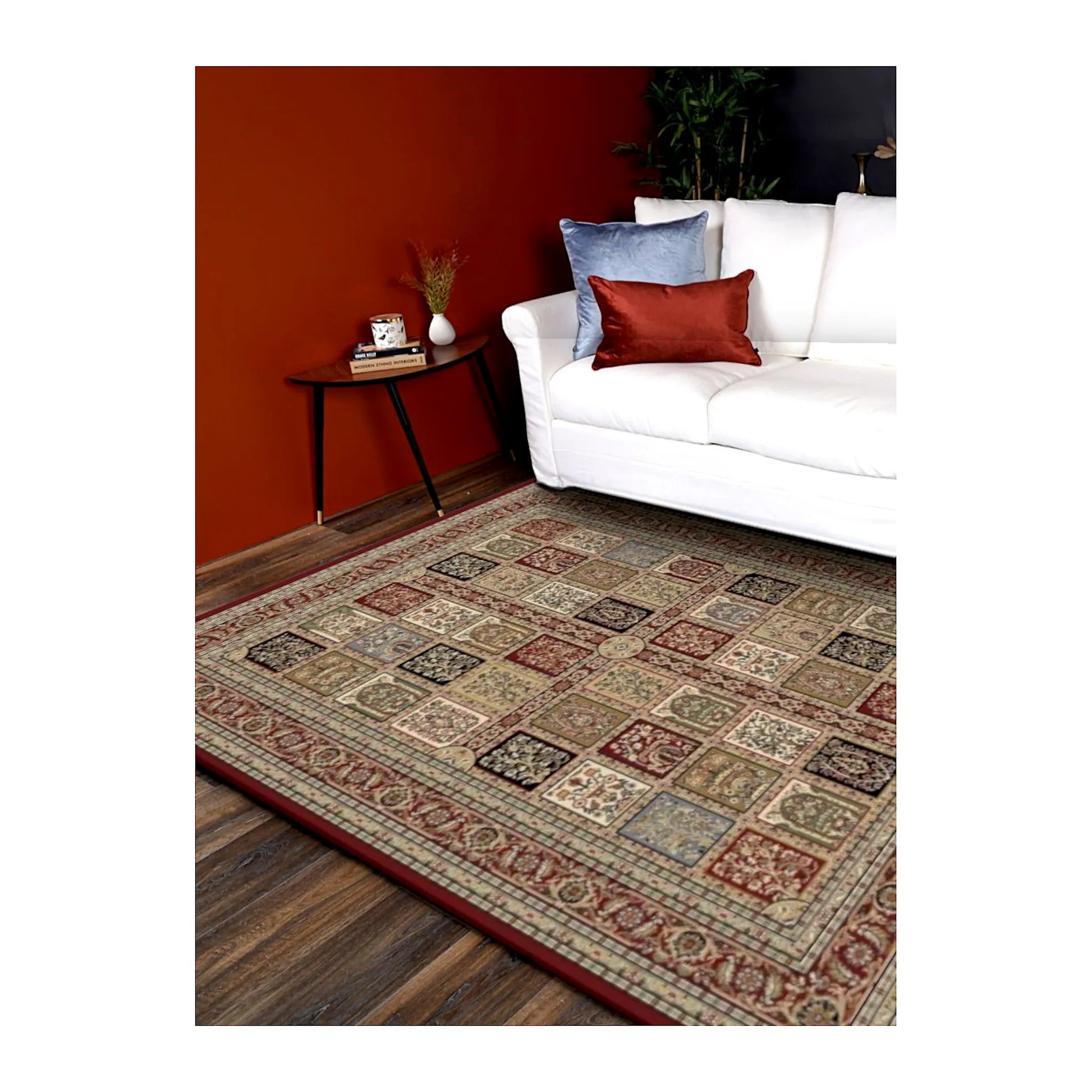 Styled room view of the Turkish Isfahan rug beside a white sofa on a dark timber floor