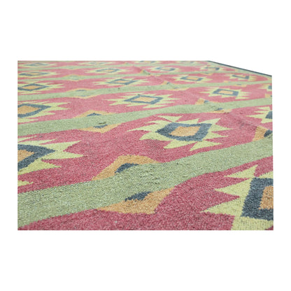 Geometric pattern detail of Turkish Kilim wool rug with dusty pink, sage green and cream motifs, 200 x 144 cm