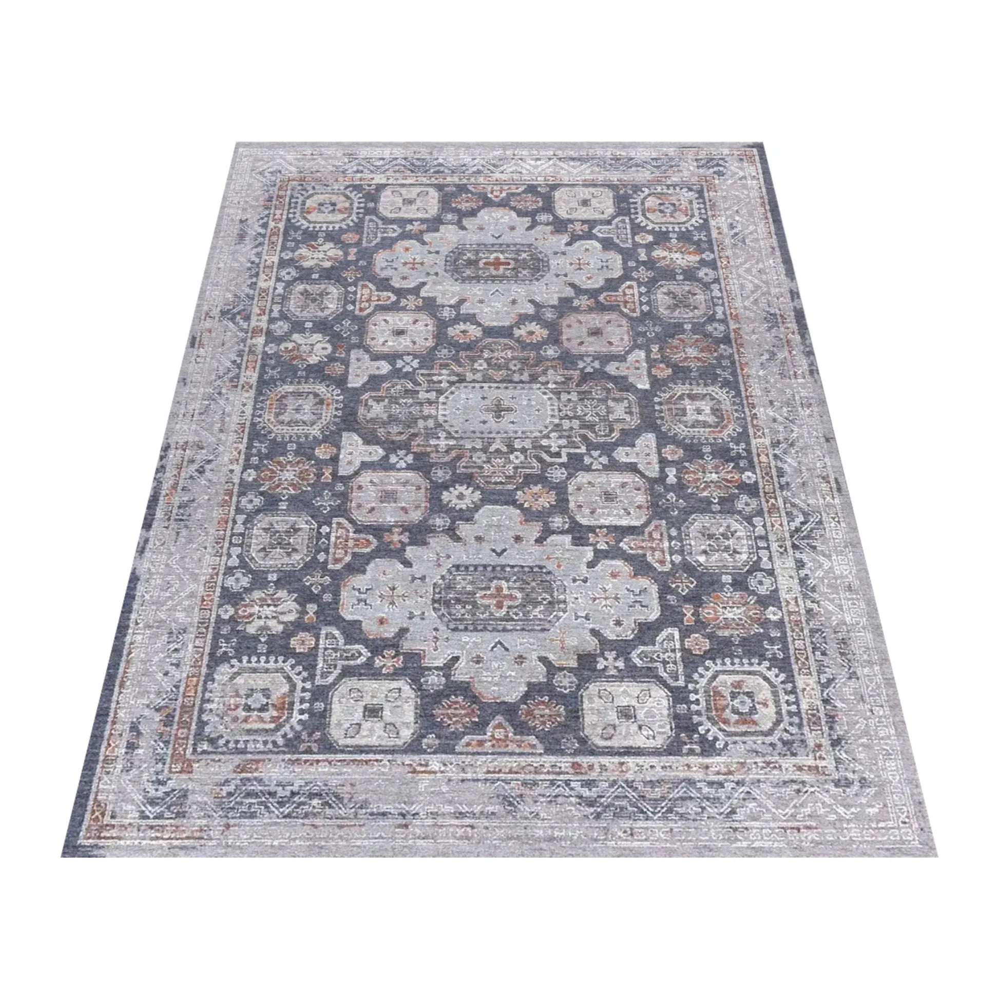 Angled full view of the charcoal Kazaki rug with layered grey borders and muted rust accents