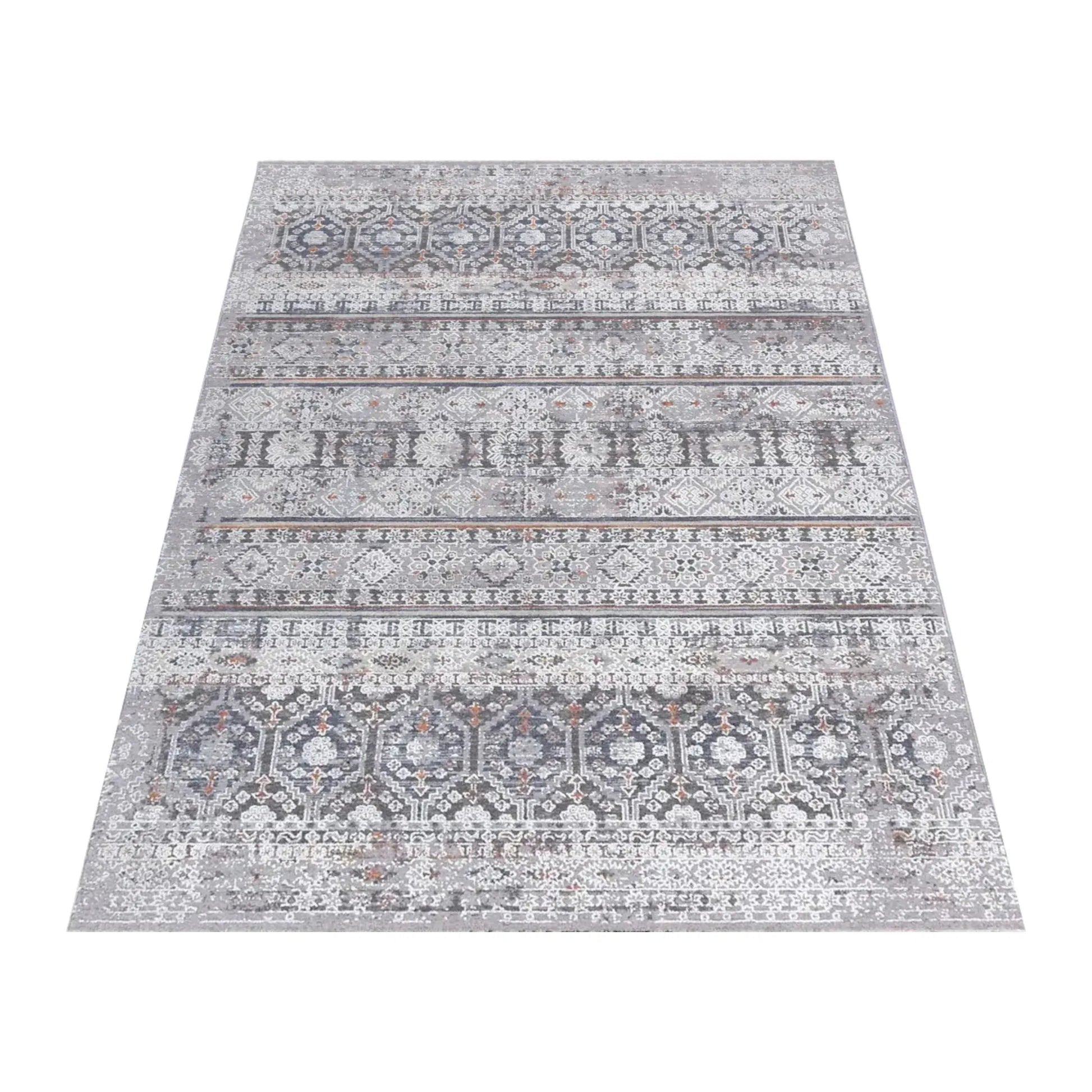 Angled full view of the Turkish Zagros rug showing layered grey geometric stripes and rust accents