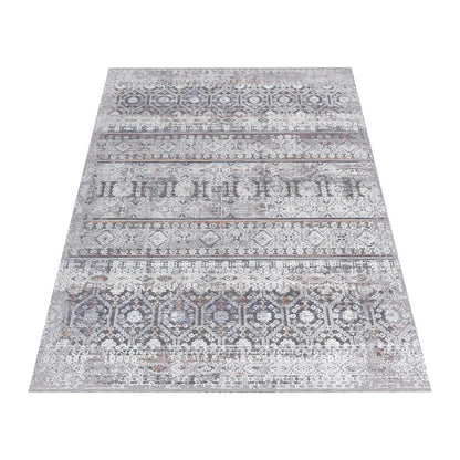 Angled full view of the Turkish Zagros rug showing layered grey geometric stripes and rust accents