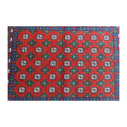 Field detail of Turkoman rug showing ivory-centred octagonal guls alternating with green diamond motifs
