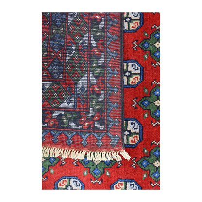 Folded-corner detail of Turkoman rug showing the reverse weave, red gul field and pale fringe
