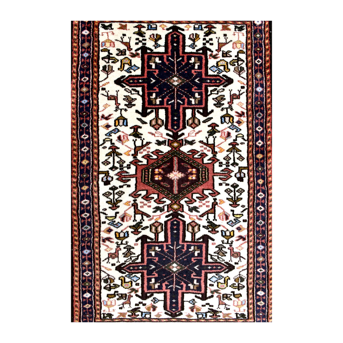 Field detail of vintage Afshar rug showing two navy stepped medallions, a rust-red central medallion and scattered animal and duck motifs