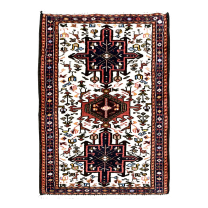 Full view of vintage Afshar wool rug with ivory field, navy stepped medallions, rust-red centre and animal and duck motifs, 105 x 65 cm