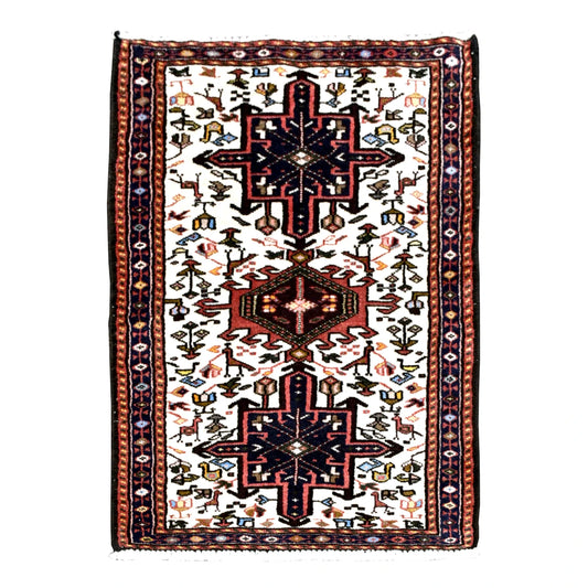 Full view of vintage Afshar wool rug with ivory field, navy stepped medallions, rust-red centre and animal and duck motifs, 105 x 65 cm