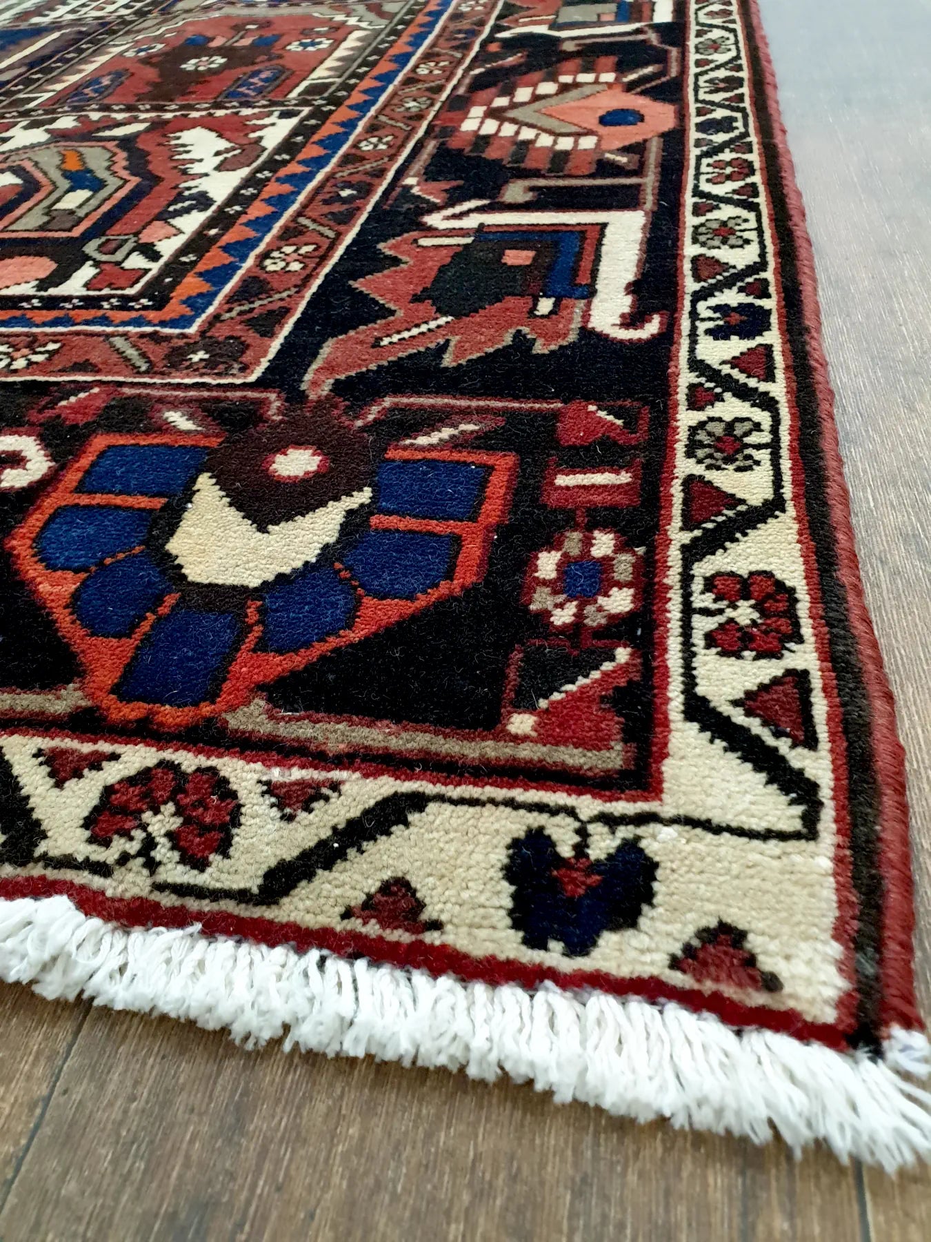 Angled view of vintage Bakhtiari wool rug 325 x 210 cm