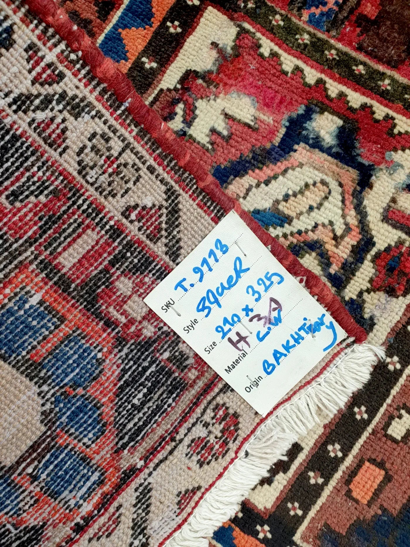 Back of vintage Bakhtiari rug showing hand-knotted weave