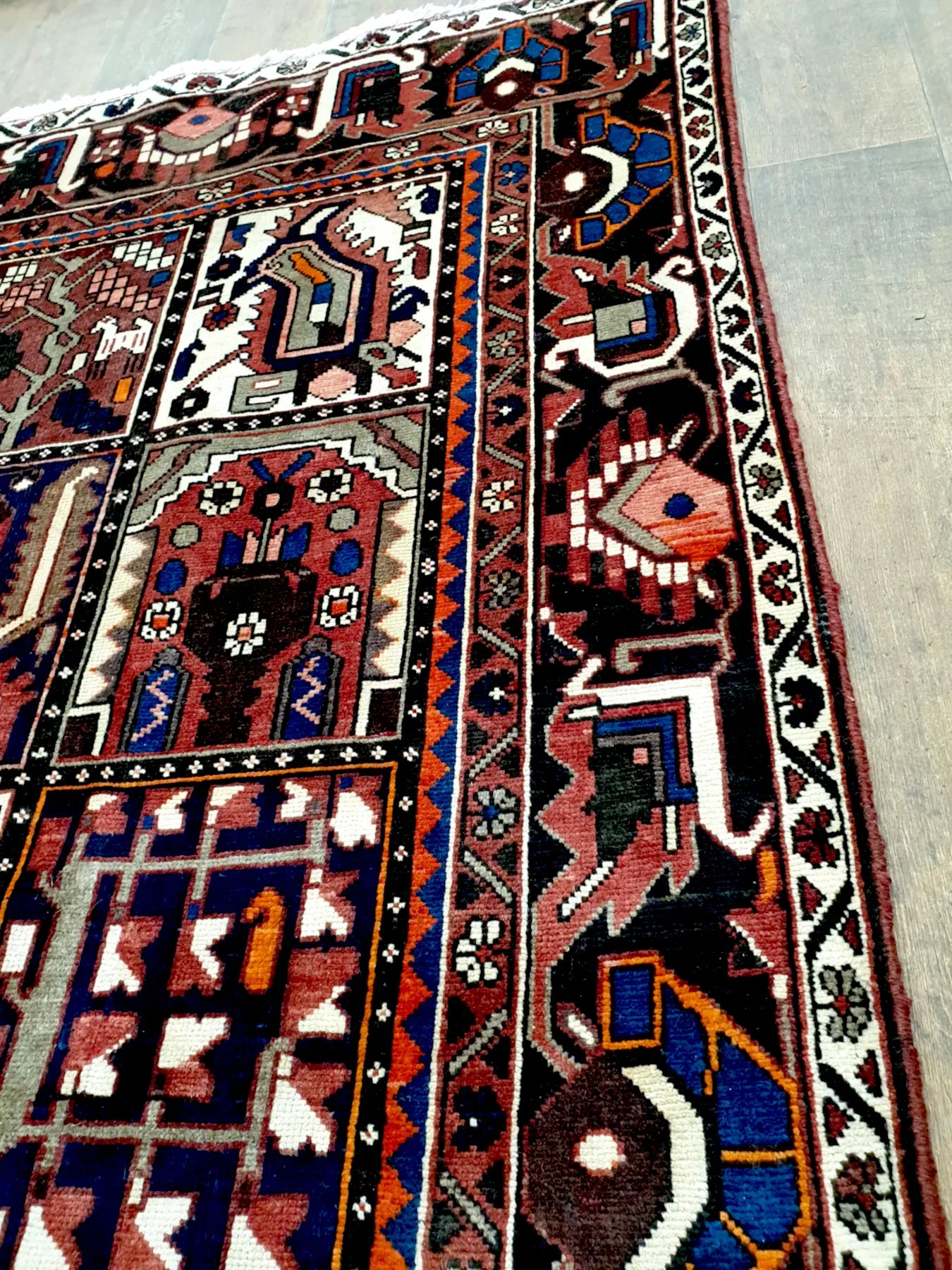 Detail view of Bakhtiari rug with multicolour Persian motifs