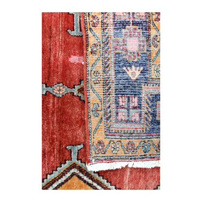 Folded-corner detail of Persian Afshar rug showing the reverse weave, brick-red front and geometric border