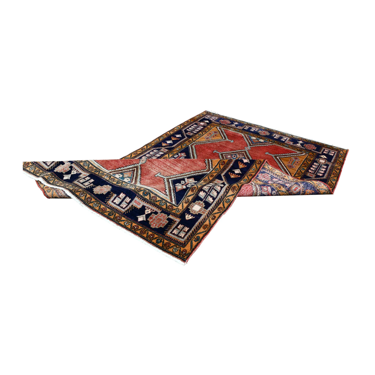 Folded view of vintage Persian Afshar hand-knotted wool rug showing its medallion field, navy borders and fringe