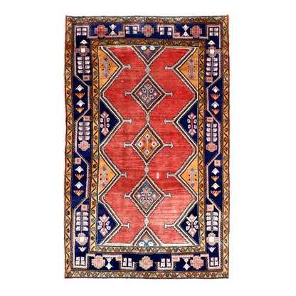Full view of vintage Persian Afshar hand-knotted wool rug with brick-red field, three diamond medallions and navy borders, 250 x 147 cm