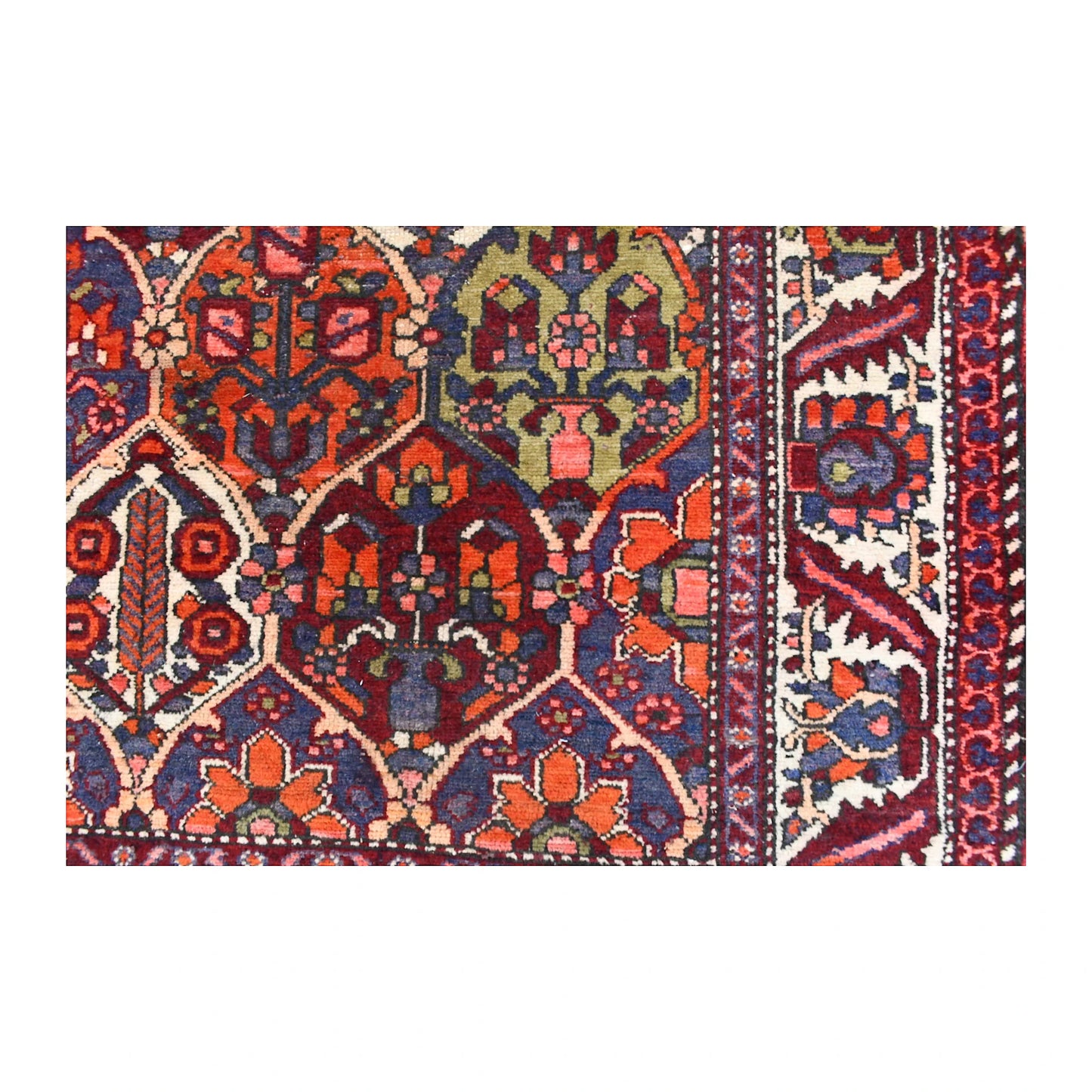 Close-up of vintage Bakhtiari rug showing pointed garden compartments, a green flowering-vase panel and ivory floral border
