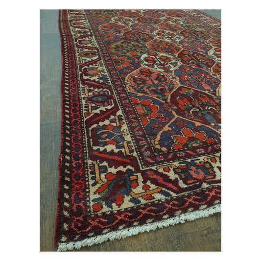 Side border and fringe detail of vintage Persian Bakhtiari wool rug with multi-colour pattern