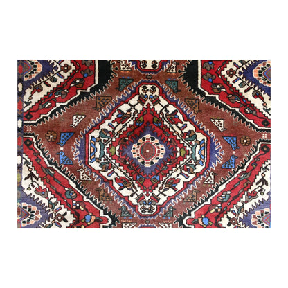 Central diamond detail of Persian Bakhtiari rug showing nested red, ivory, navy and blue geometric forms