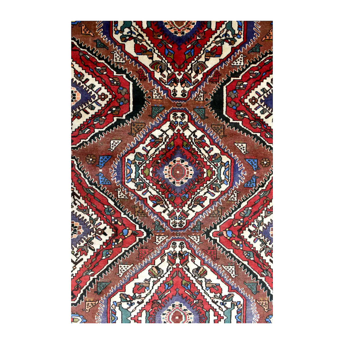 Field detail of vintage Bakhtiari rug showing layered diamond medallions between rust-brown chevrons and ivory spaces