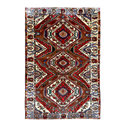 Full view of vintage Persian Bakhtiari wool rug with three diamond medallions, rust-red chevrons and ivory floral border, 287 x 155 cm