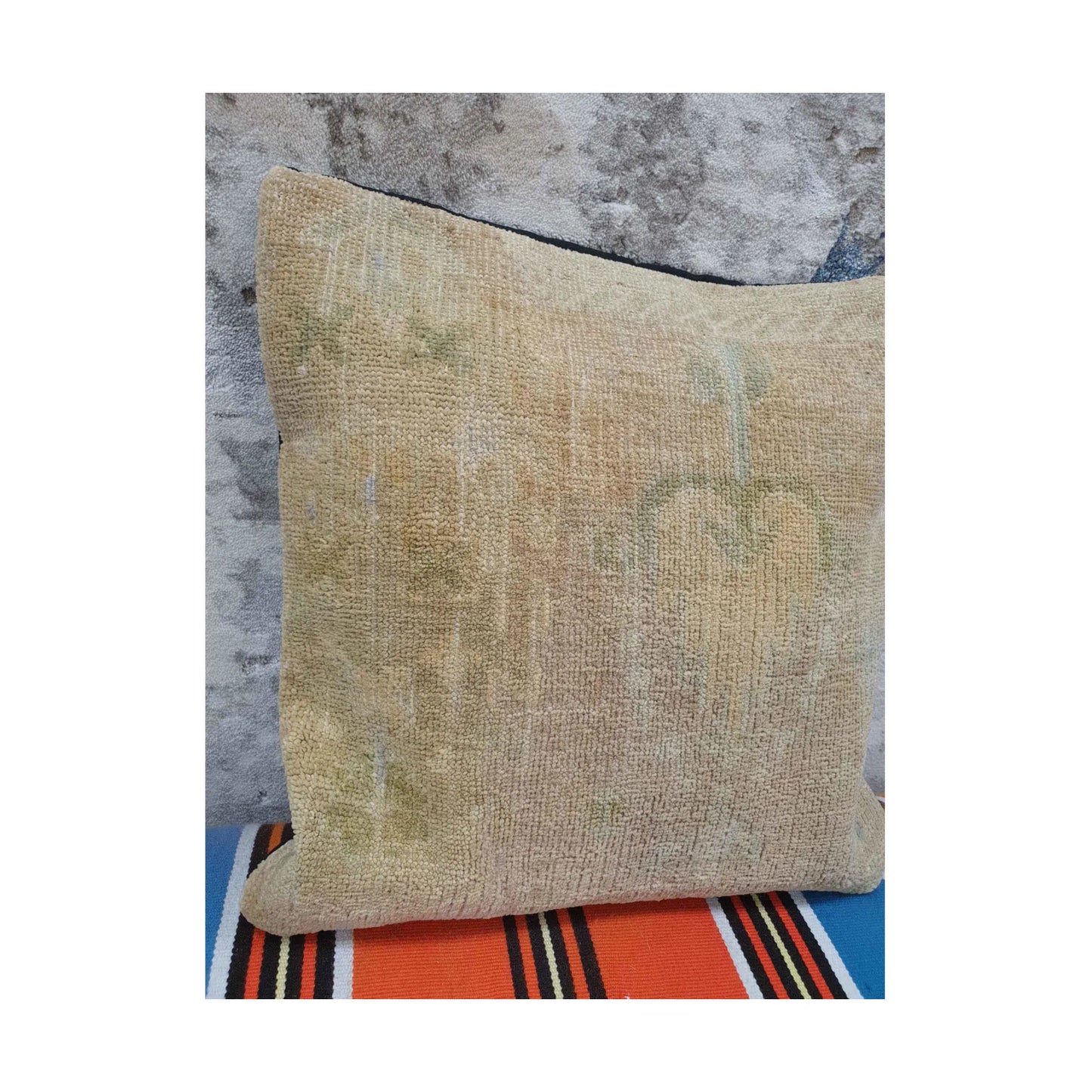 Closer view of beige wool pile showing muted olive-grey floral and linear traces
