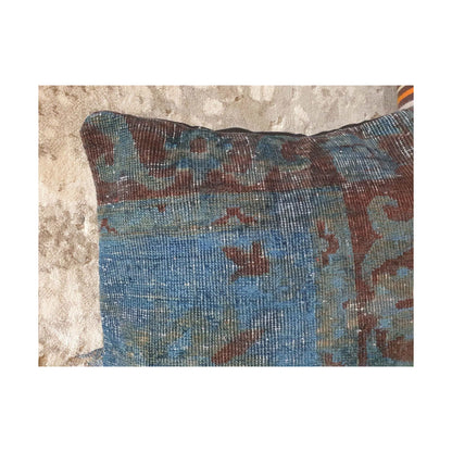 Close-up of dusty blue, muted blue-green and burgundy patterning across the upper section of the Persian cushion cover