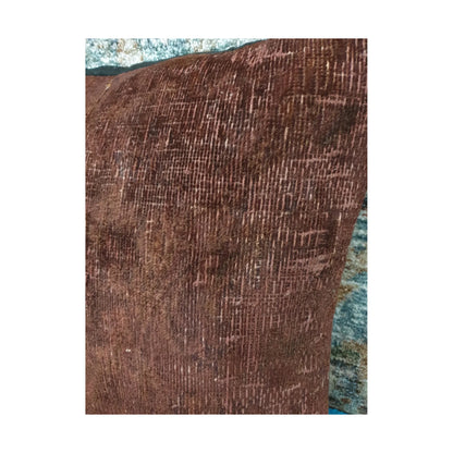 Close-up of brown wool pile showing faded grid-like Persian pattern traces