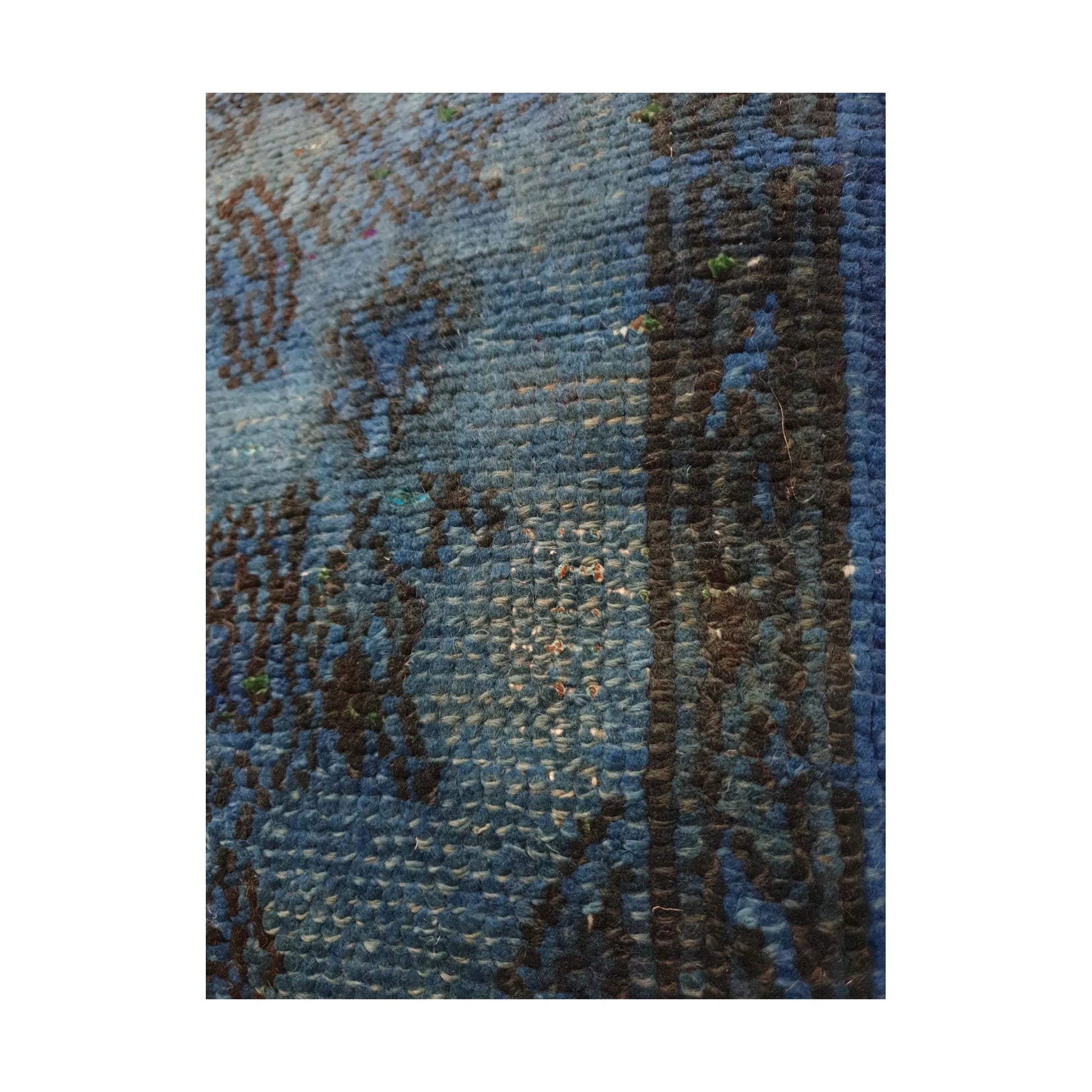 Close-up of lighter blue wool pile and dark charcoal pattern outlines on the vintage Persian cushion cover