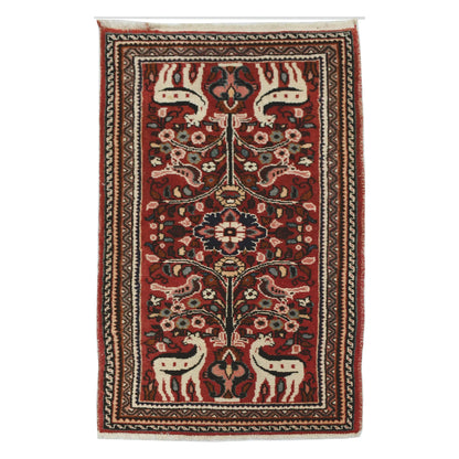 Full view of vintage Persian Hamadan hand-knotted wool rug with deep red field, animal motifs, central medallion and border, 126 x 72 cm