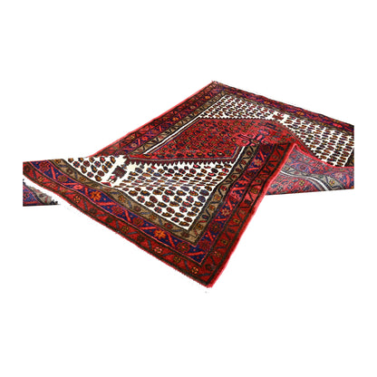 Folded view of vintage Persian Hamadan hand-knotted wool rug showing its medallion field, borders and pale fringe