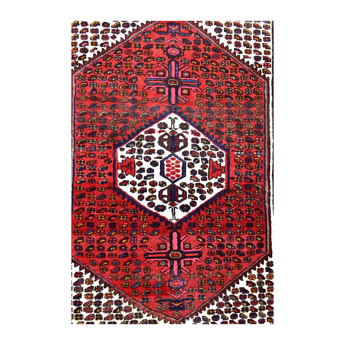 Field detail of vintage Persian Hamadan rug showing a red hexagonal composition, ivory medallion and cream boteh spandrels