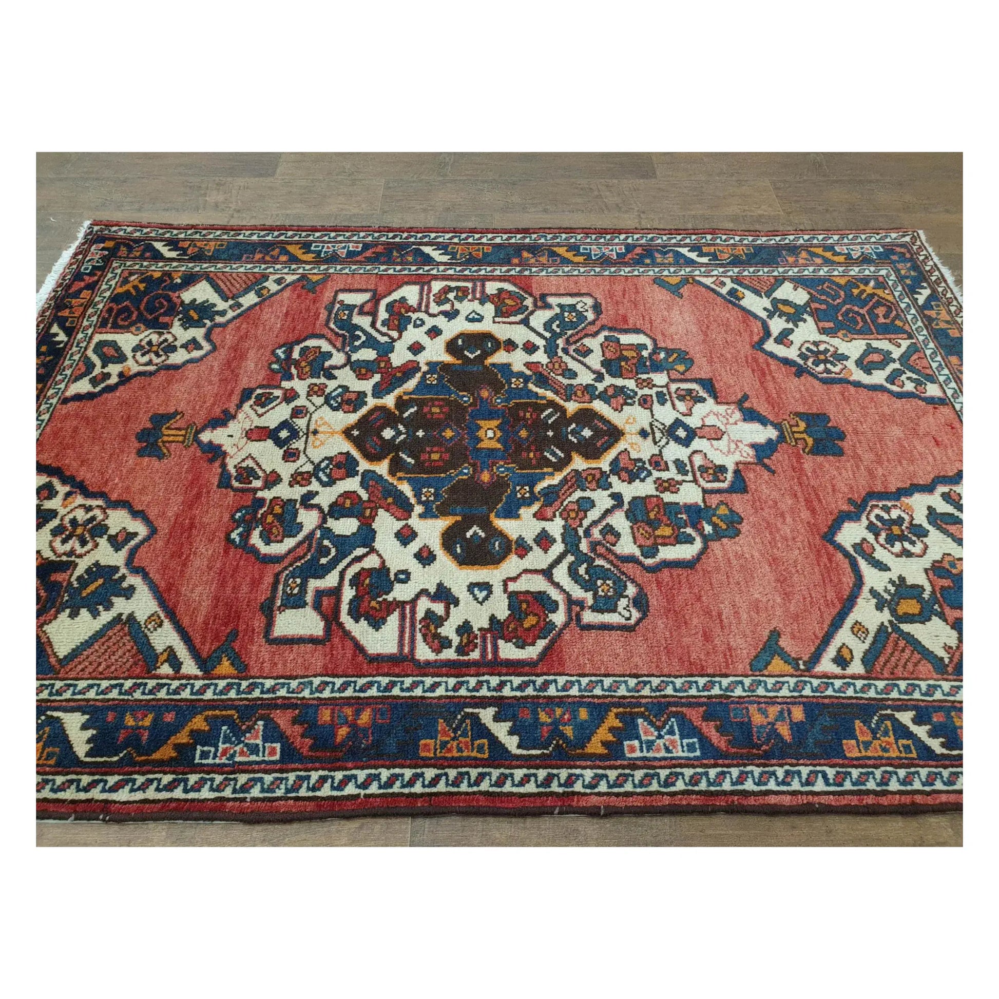 Angled full view of vintage Persian Hamadan rug showing medallion field and border