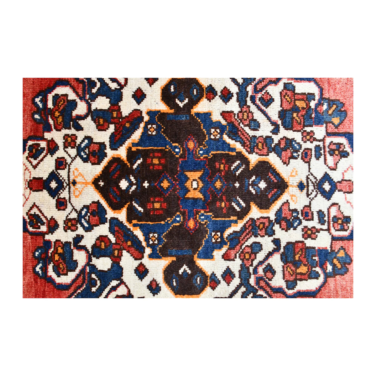 Central medallion close-up of Hamadan wool rug with dark navy, ivory, rust and muted blue motifs
