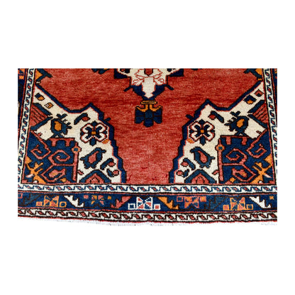 End-border and corner-spandrel detail of Persian Hamadan rug in warm red, ivory, dark navy and rust
