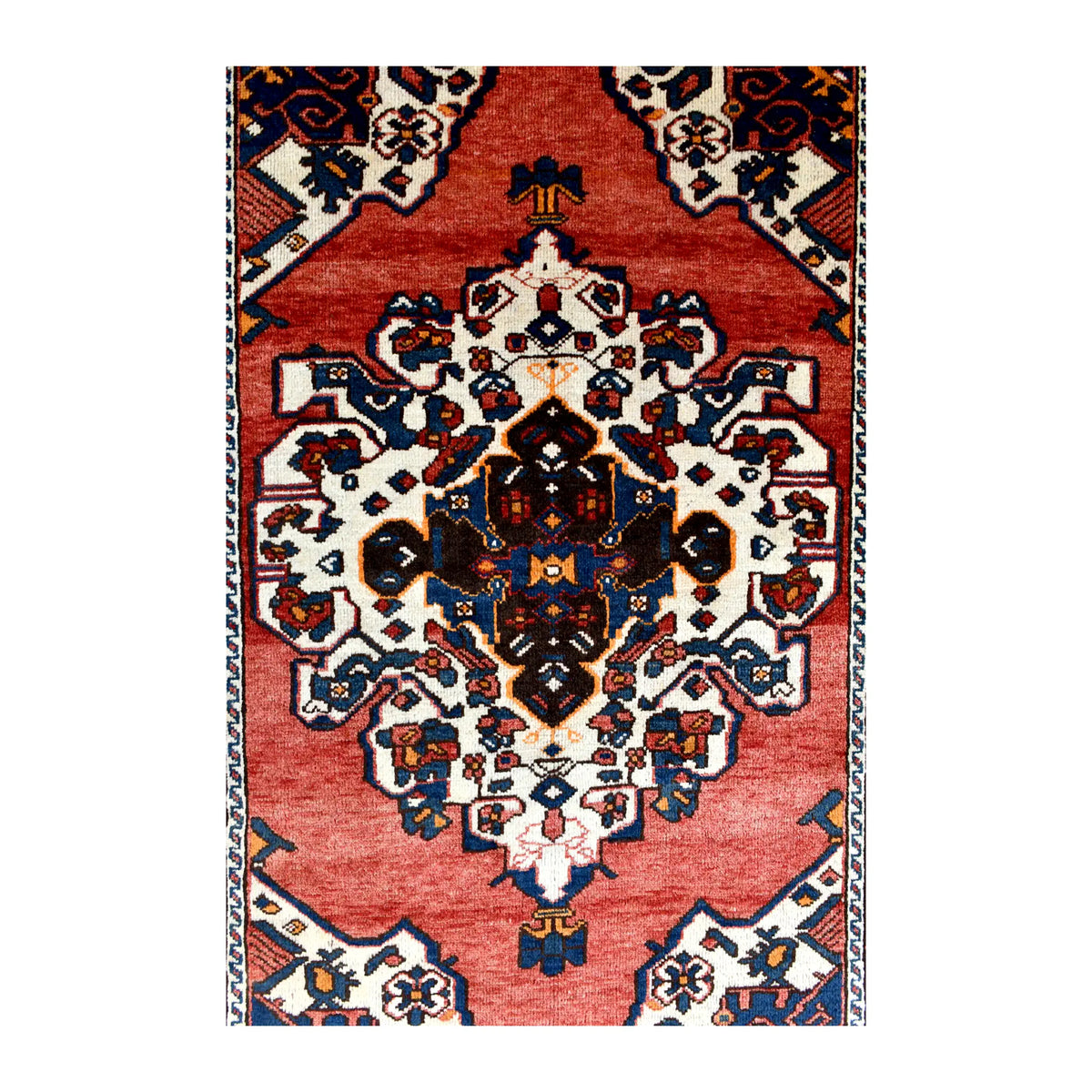 Field detail of vintage Persian Hamadan rug showing its layered central medallion and ivory corner spandrels