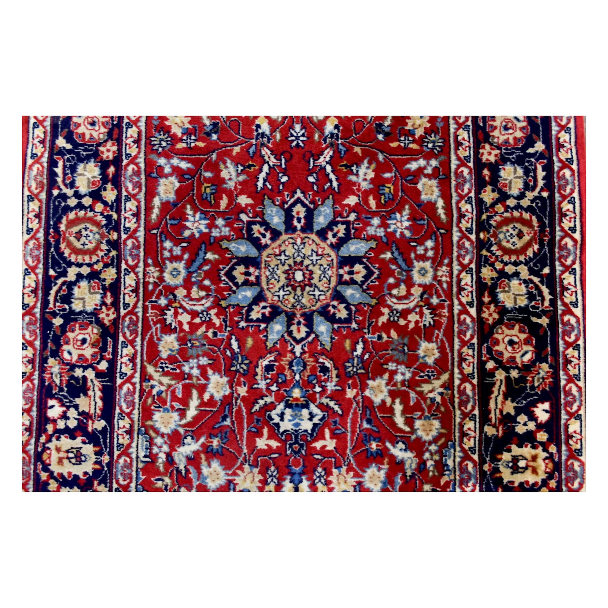 Sectional view of vintage Kashan runner showing a pale-blue rosette medallion on the red vine field, centred between matching navy floral borders