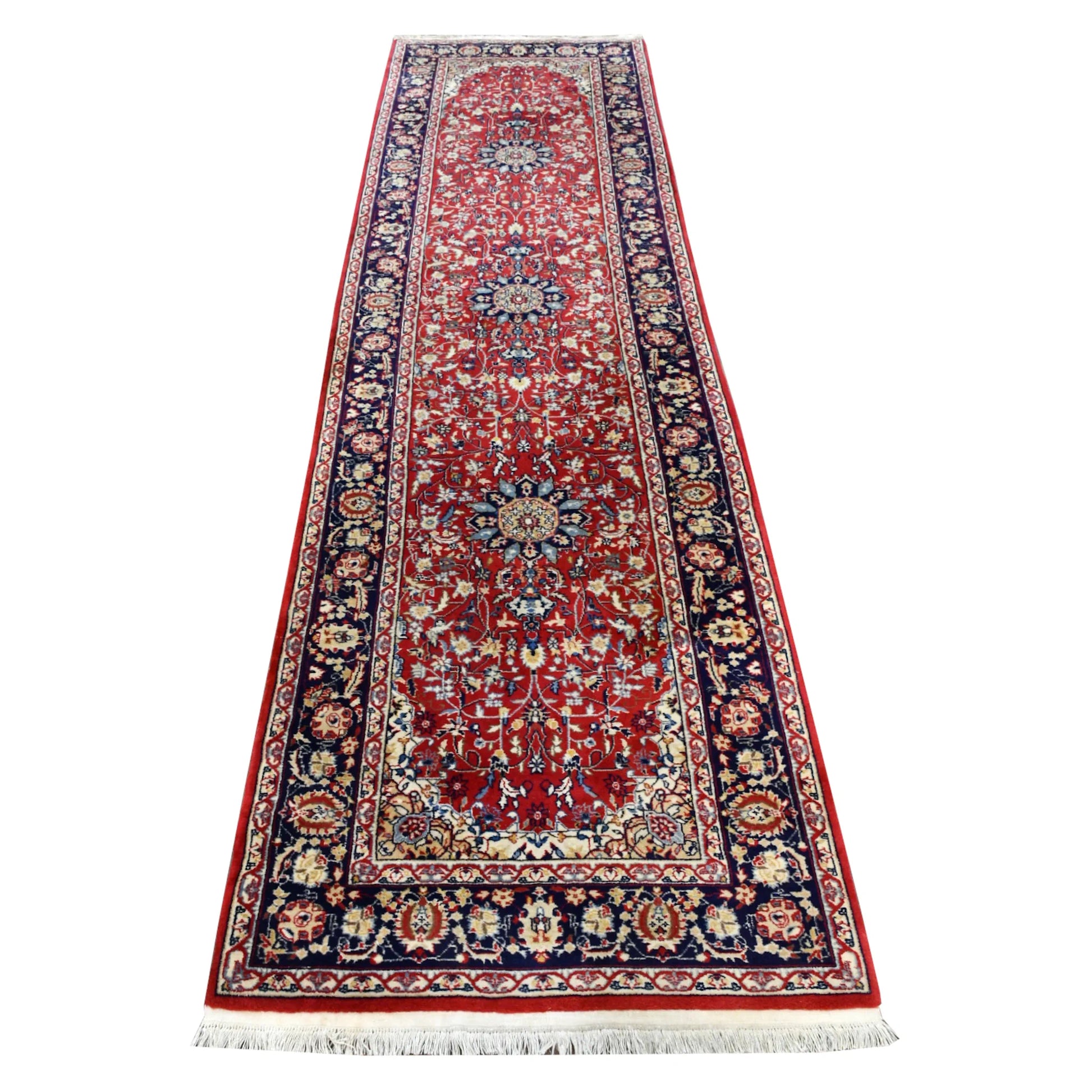 Full view of vintage Persian Kashan hand-knotted wool runner with a red floral field, blue medallions and navy border, 350 x 92 cm