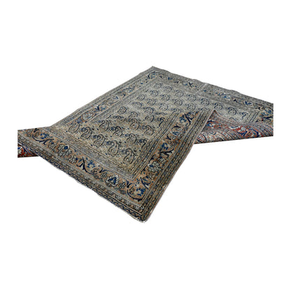 Folded view of Mashad Dorakhash rug showing its pale boteh field and layered floral borders