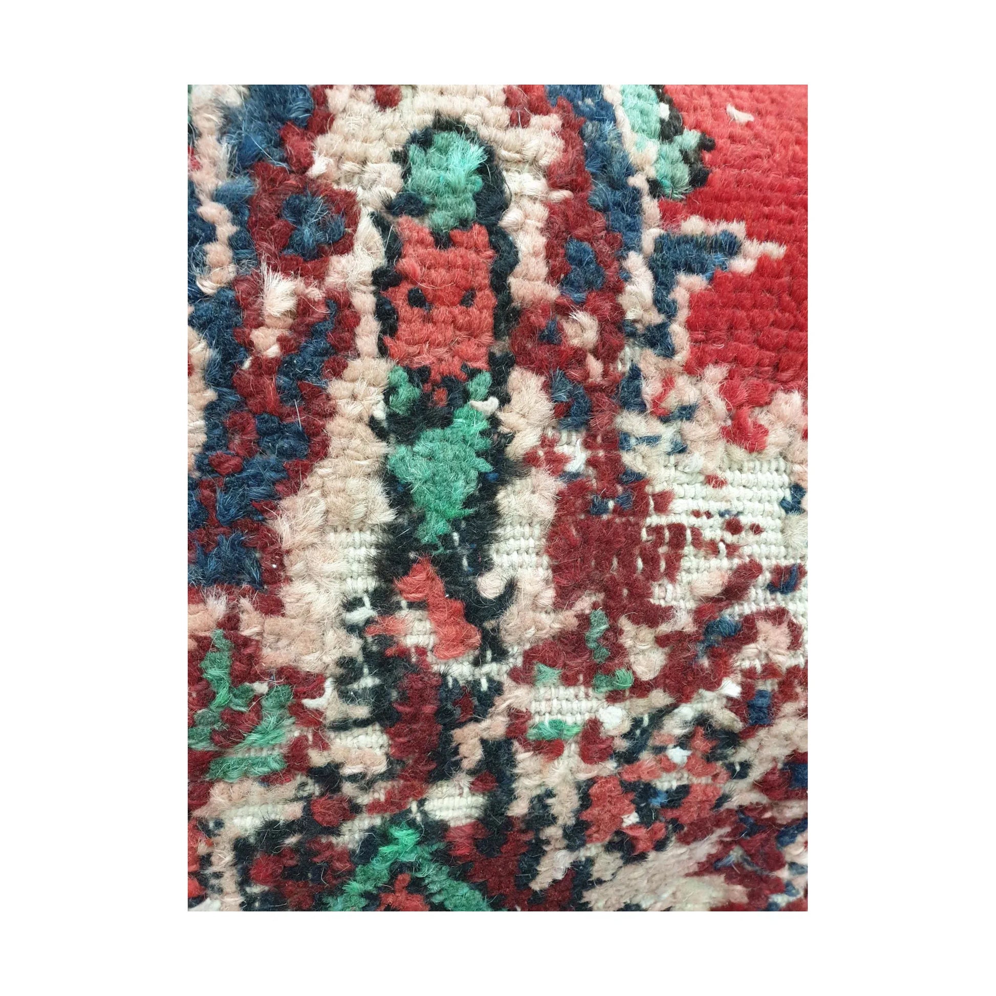 Detailed close-up of layered ivory, navy, green and red Persian motif fragments